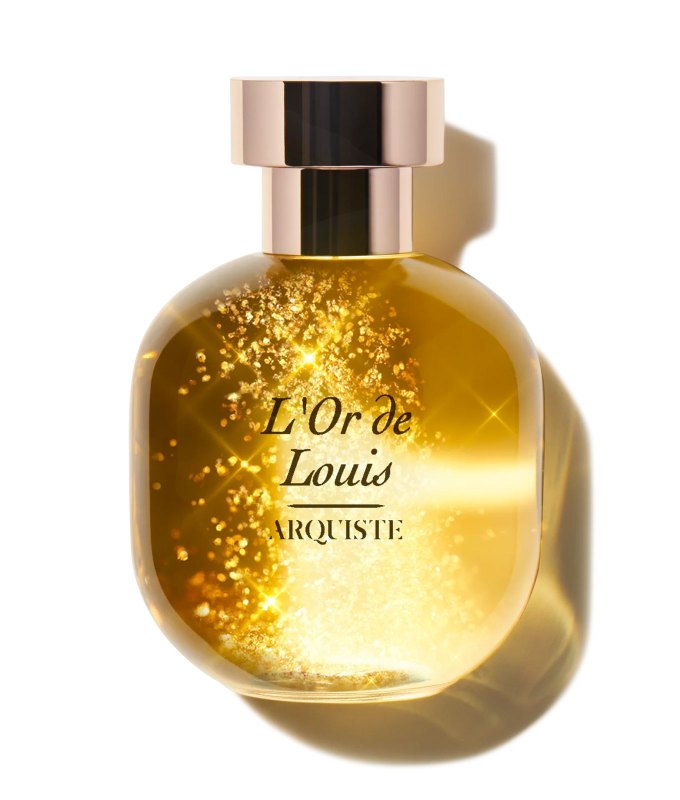 best-bedtime-perfume: A round perfume bottle with a golden color liquid inside. It has flecks of gold inside and seems to shine.