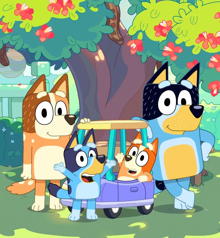 best-bluey-episodes: A screenshot of Bluey and her family in front of a tree with pink flowers. They are in the shade of the tree and the steps to their porch are behind them.