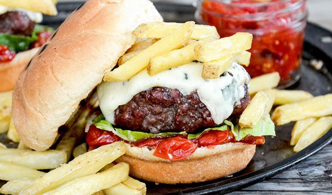 best burger recipes: burger with blue cheese and tomato jam on a plate with fries