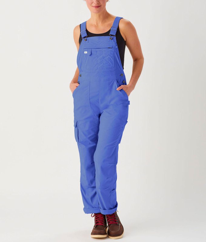 best-gardening-gifts: A woman wears a pair of bright blue overalls for gardening.
