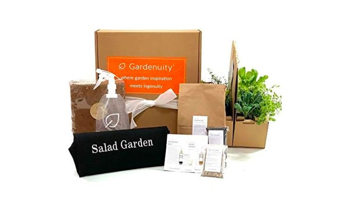best-gardening-gifts: A couple of boxes from Gardenuity that are opened showing the contents. Some are filled with plants and other with gardening materials. Everything sits in front of a white background.