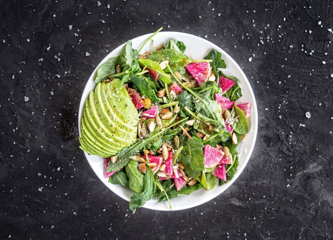 bowl of salad with avocado and radishes