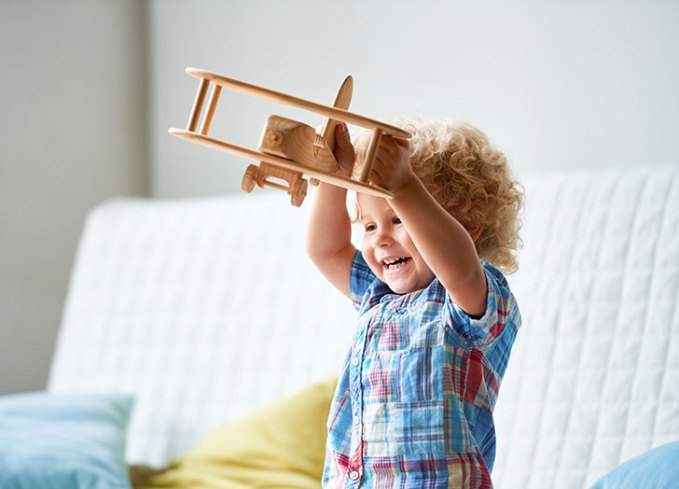 cute kid playing with toy airplane