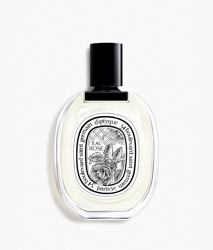 best-bedtime-perfume: A round and flat perfume bottle with an intricate label featuring a black and white floral design.