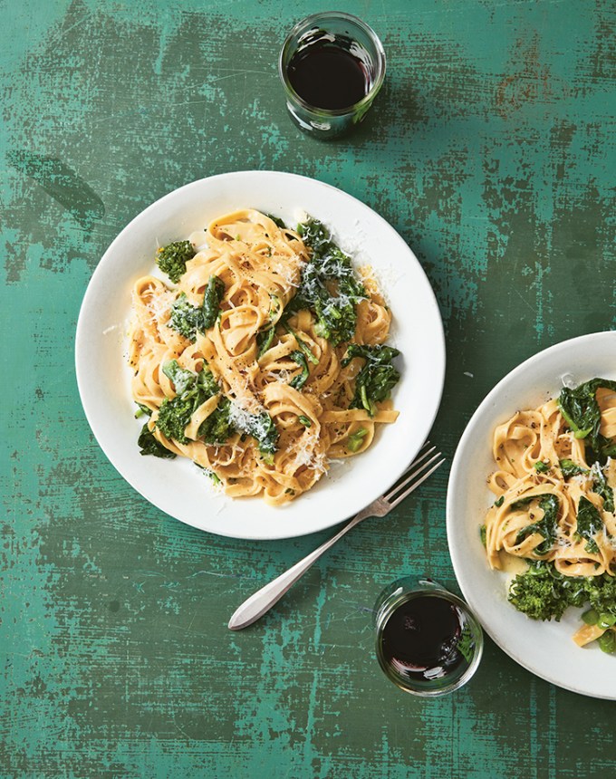 easy dinner recipes: two plates of green-topped pasta on a green backdrop