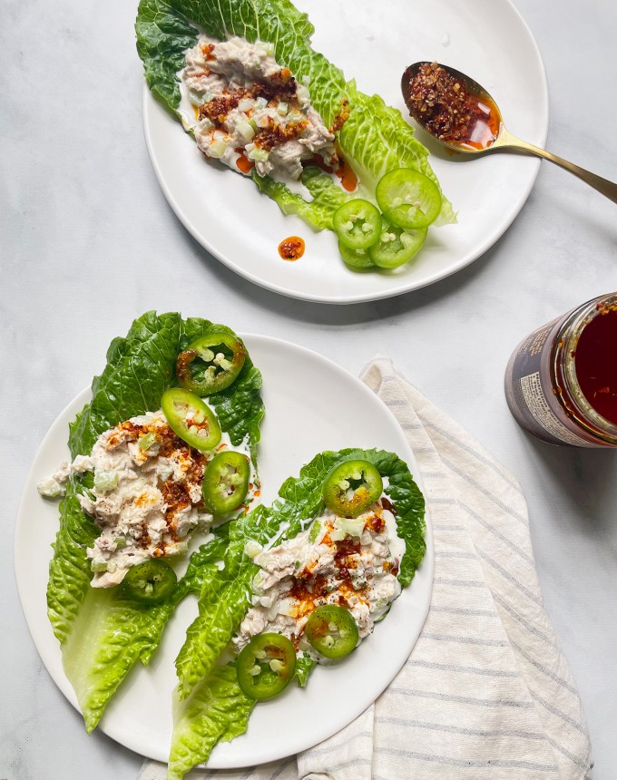 easy dinner recipes: two plates of tuna-filled lettuce cups topped with chile crisp