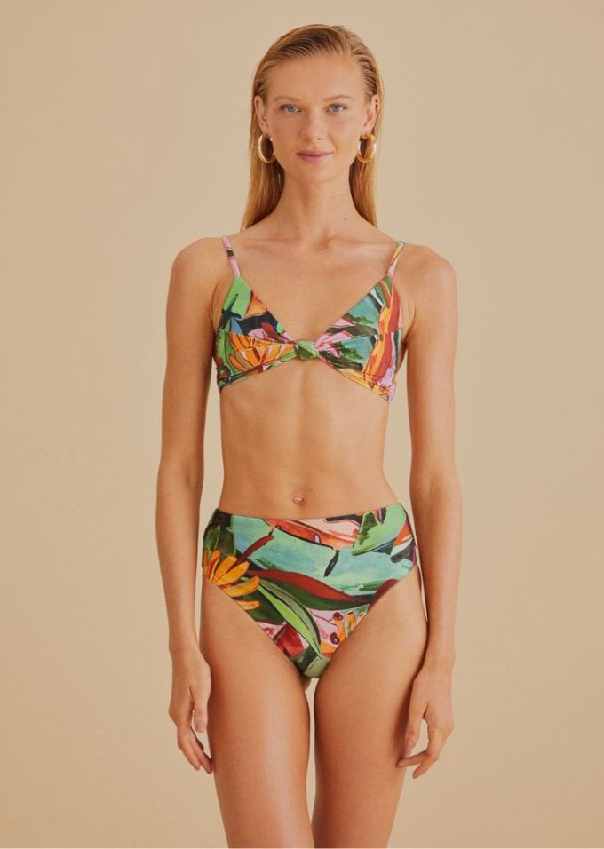 Blonde woman wearing tropical high waisted bikini