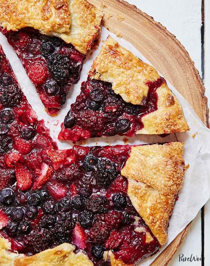 fun things to bake: close-up of sliced mixed berry galette on a wooden slab