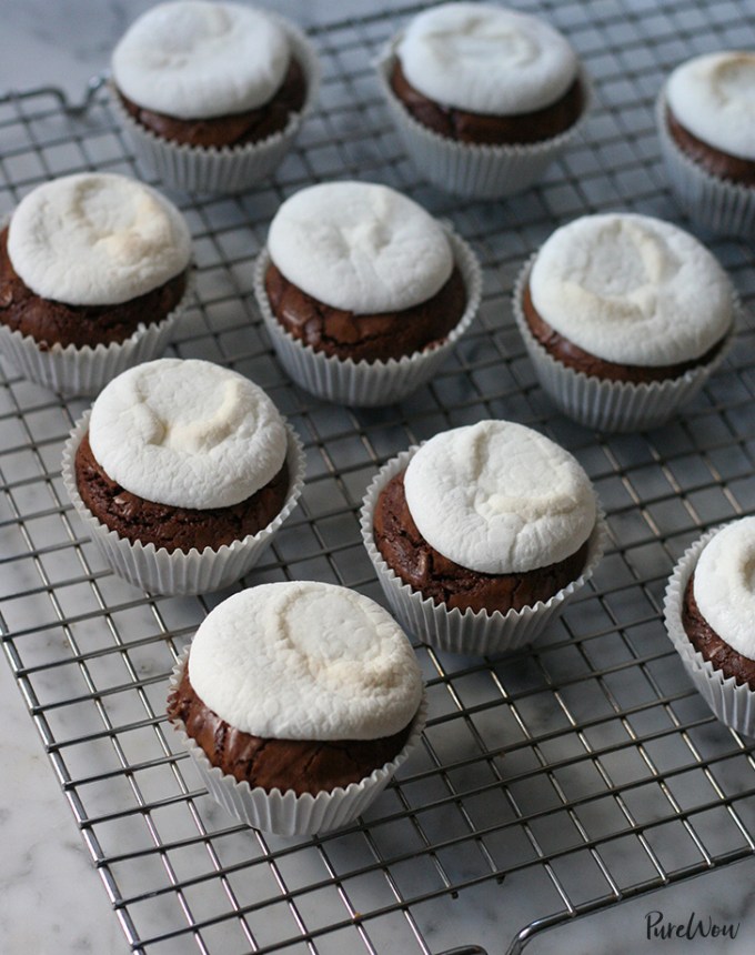 fun things to bake: brownie cupcakes topped with melted marshmallows, on a cooling rack