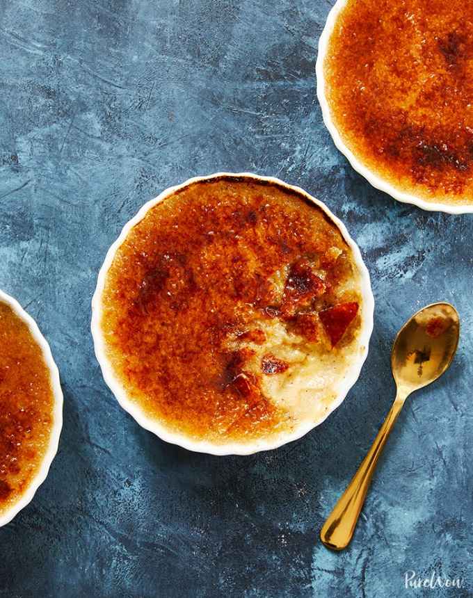 fun things to bake: aerial of three cardamom creme brulees on a blue counter