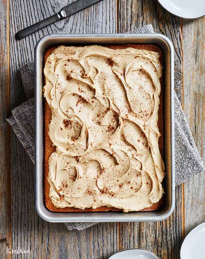 fun things to bake: aerial of cinnamon sheet cake with cider frosting on a wooden table