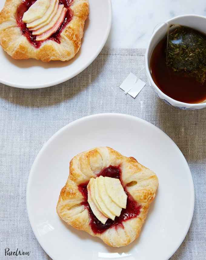 fun things to bake: aerial of two cranberry-apple danishes on plates with a cup of coffee