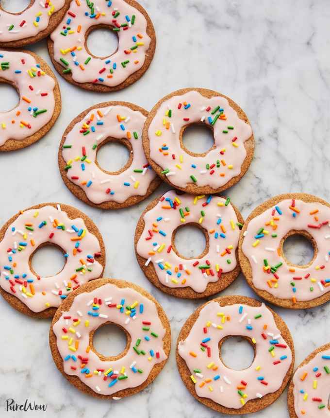 fun things to bake: brown sugar cookies shaped like doughnuts and decorated with pink glaze and rainbow sprinkles