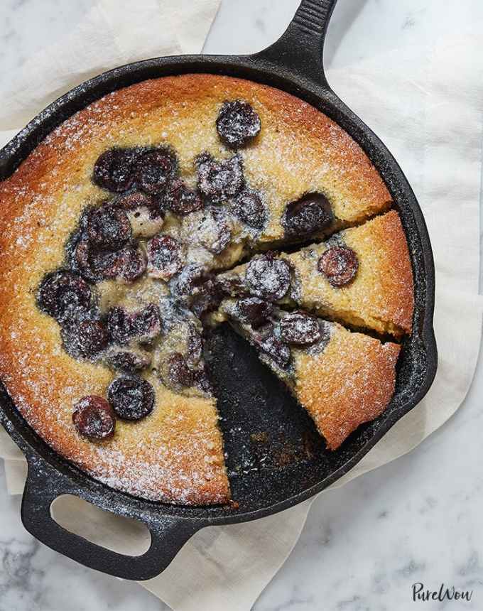 fun things to bake: easy cherry skillet cake in a cast iron skillet with a slice missing