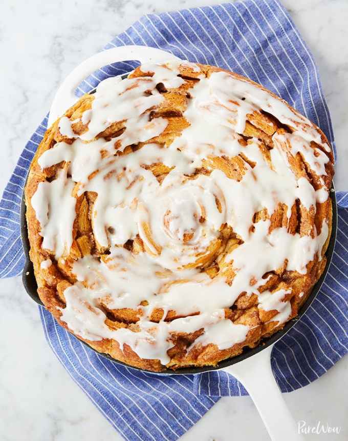 fun things to bake: giant cinnamon roll in a skillet, atop a blue linen