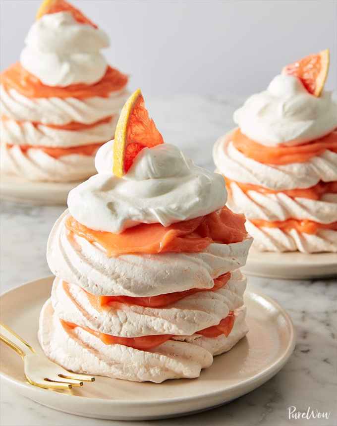 fun things to bake: three grapefruit meringue stacks topped with whipped cream and a slice of grapefruit