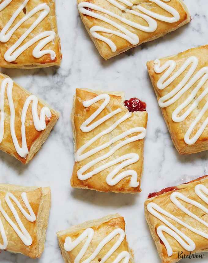 fun things to bake: nine homemade toaster pastries drizzled with vanilla glaze, on a marble counter