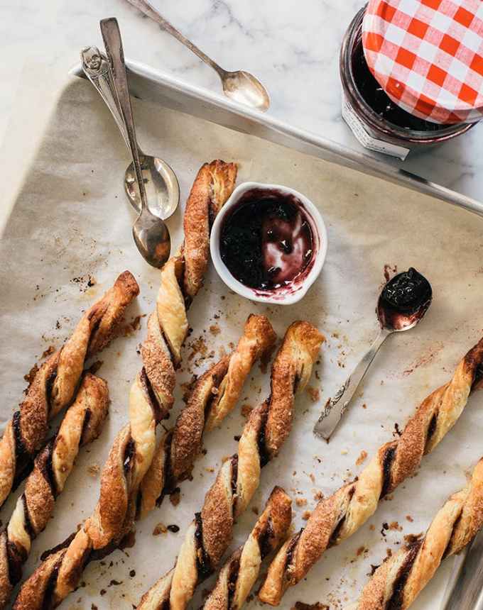 fun things to bake: seven blackberry pie crust straws on a parchment-lined baking sheet