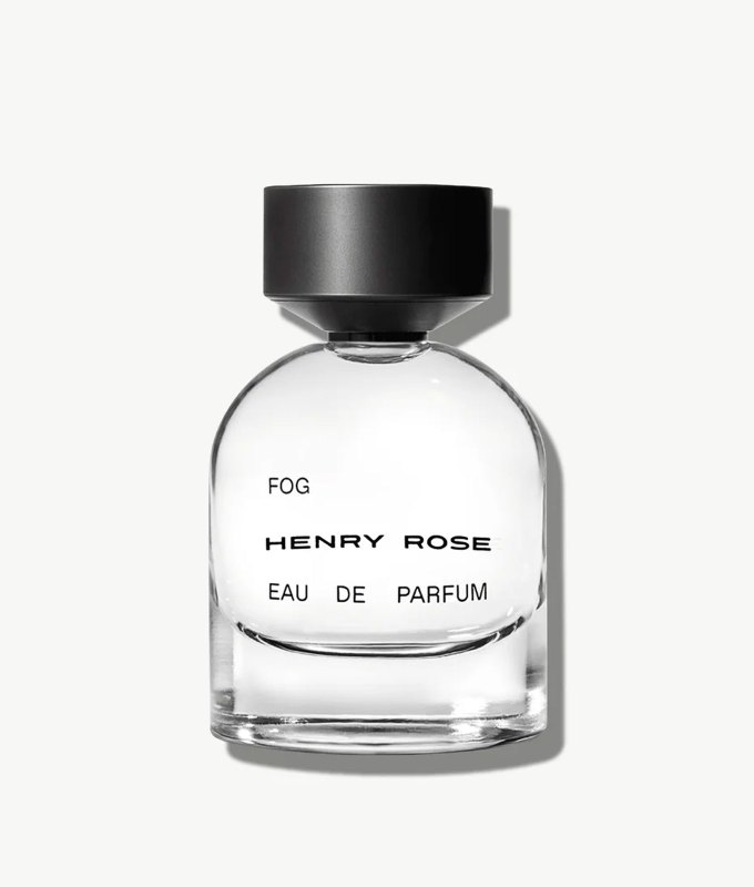 best-bedtime-perfume: A modern looking perfume bottle with a round shape and a black cylindrical cap.