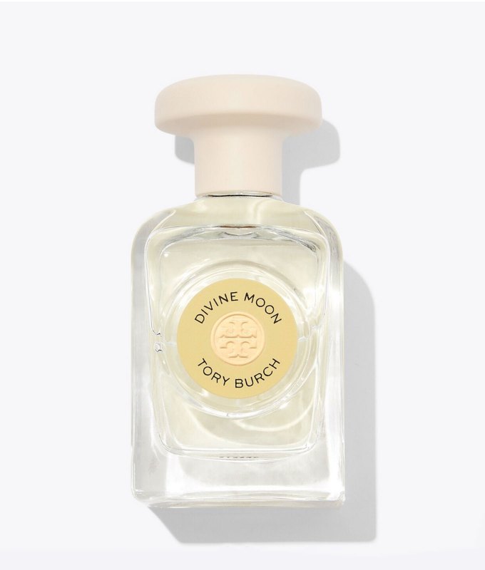 best-bedtime-perfume: A clear bottle of perfume with a yellow circular label and a cream colored cap in front of a white background.